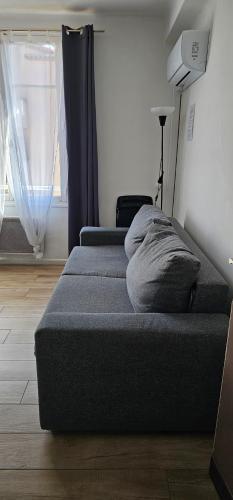 two beds sitting in a room with a window at Studi'Hotel cœur Sablettes CLIM parking H24 total autonomie in La Seyne-sur-Mer