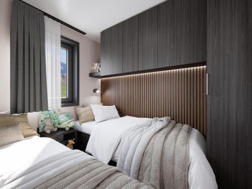 a bedroom with two beds and a window at Austria Parks - Camping Arlberg GmbH in Pettneu am Arlberg