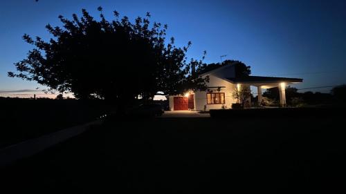 a small white house with a tree in front of it at Villa Caporotondo in Pisticci