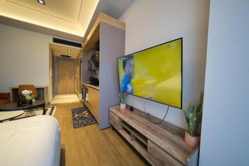 a living room with a large flat screen tv on a wall at The Diamond In City Luxury Suites By ZENORA Living in Accra