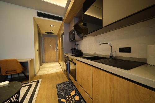 a kitchen with a sink and a counter top at The Diamond In City Luxury Suites By ZENORA Living in Accra