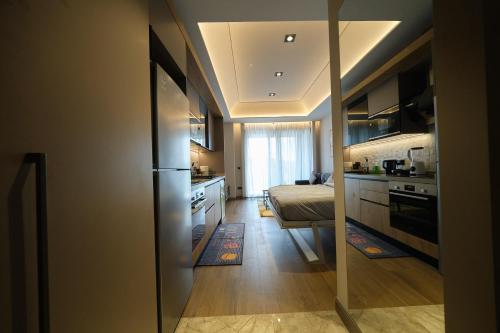 a kitchen with a refrigerator and a bed in a room at The Diamond In City Luxury Suites By ZENORA Living in Accra
