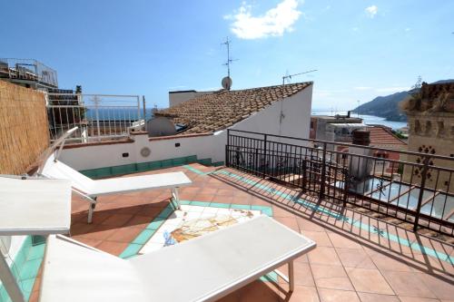 a balcony with a table and chairs on a building at Dalla torre al mare in Vietri sul Mare
