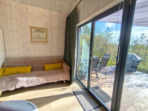 a bedroom with a bed and a sliding glass door at Metsamarja in Rässa