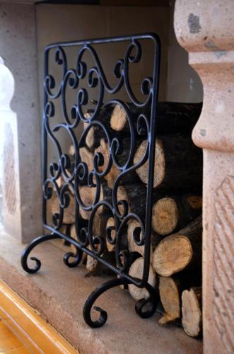 a mirror sitting next to a pile of logs at Fragrante Hotel - Adult Only (+13) in Ayvalık
