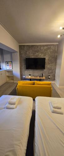 a hotel room with two beds and a flat screen tv at DREAM HOUSE 2 Montes Burgos PORTO in Porto