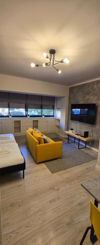 a living room with a yellow couch and a tv at DREAM HOUSE 2 Montes Burgos PORTO in Porto