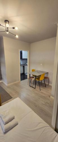 a living room with a table and chairs and a piano at DREAM HOUSE 2 Montes Burgos PORTO in Porto