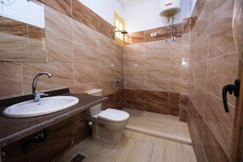 a bathroom with a sink and a toilet and a shower at Luxor Hotel in Luxor