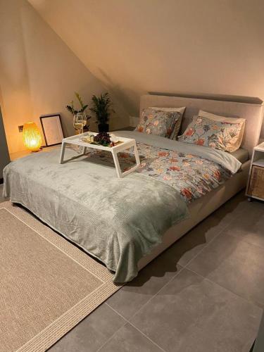 a bedroom with a bed with a table on it at Apartament Nad Rzeczką in Godów