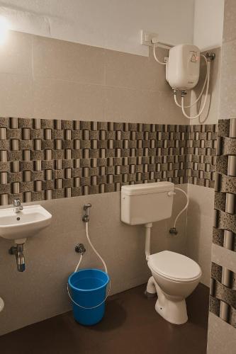 a bathroom with a toilet and a sink at Vibe Stay by Andaz in Arambol