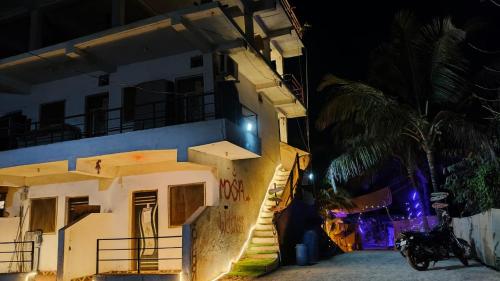 a building with a staircase leading up to it at night at Vibe Stay by Andaz in Arambol