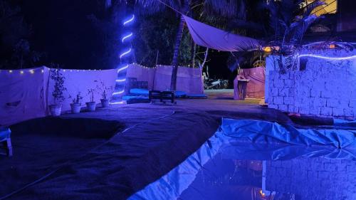 a room with a bed with blue lights on it at Vibe Stay by Andaz in Arambol
