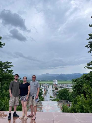 a group of three people standing on top of a building at Muong Thanh Homestay in Diện Biên Phủ
