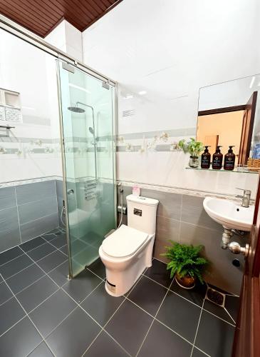 a bathroom with a toilet and a shower and a sink at CT Morning Hotel in Can Tho