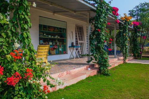 a house with a bunch of ivy growing around it at Baagh-Bohemian 6BHK Farmhouse, Jagatpura, Jaipur in Jaipur