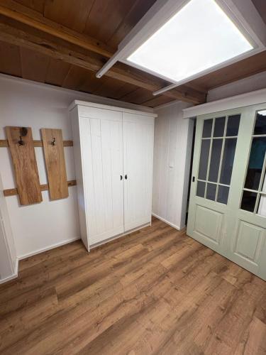 an empty room with white cabinets and a skylight at Apartmán na statku in Teplice
