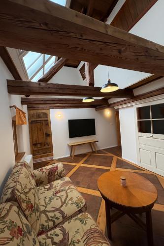 a living room with a couch and a tv at Apartmán na statku in Teplice