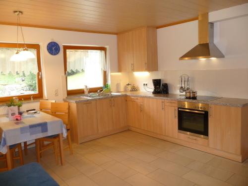 a kitchen with wooden cabinets and a table and a window at Pirchahof in Martello