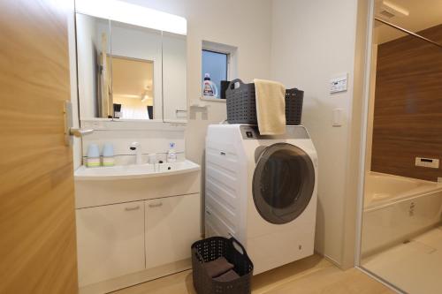 a bathroom with a washing machine and a sink at Saifu Ume - Vacation STAY 52782v in Dazaifu