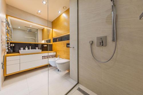 a bathroom with two toilets and a shower at Apartmán Silvie Luhačovice in Luhačovice