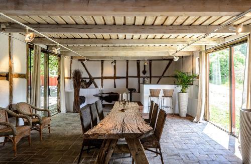 a dining room with a wooden table and chairs at Rubensholm Bed & Breakfast in Brösarp