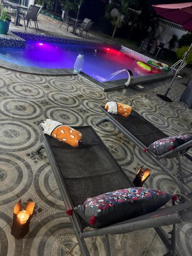 a pool with several pillows and a swimming pool at The Gambian Princess in Sukuta