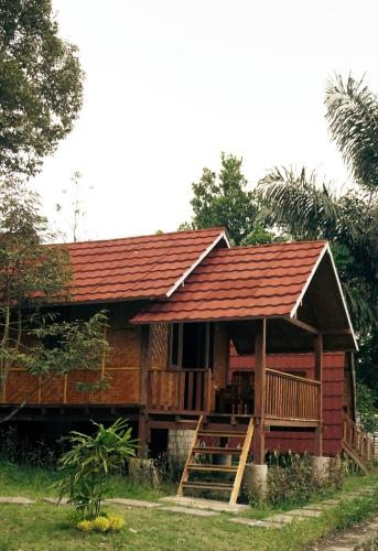 a small house with a red roof at Lalinggo Bungalow in Tetebatu
