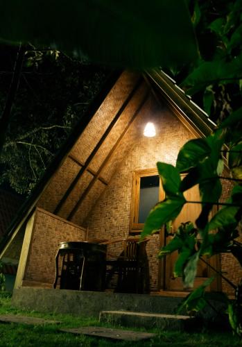 a house with a window and a table in front of it at Lalinggo Bungalow in Tetebatu