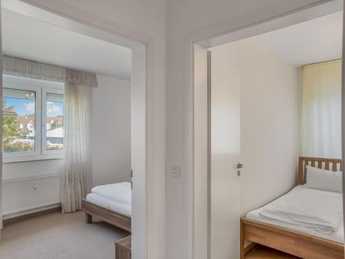 Postel nebo postele na pokoji v ubytování Objekt-Nr 11 - Priwall - Pötenitzer Weg