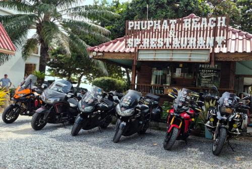 a group of motorcycles parked in front of a restaurant at Phuphat Beach Resort in Khanom