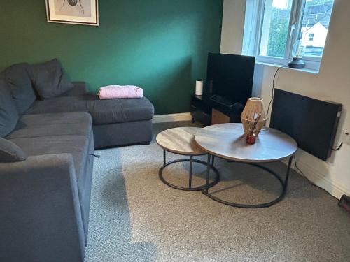 a living room with a couch and a table at Sandcastle in Swansea