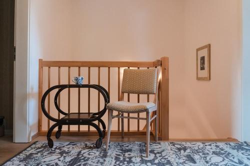 a chair and a chair sitting in a room at Anubis relaxed&stay in Hamburg