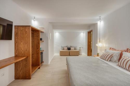 a living room with white walls and a couch at Athera Suites Mykonos in Tagou