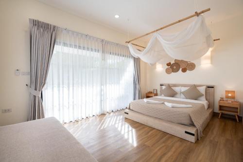 Ένα ή περισσότερα κρεβάτια σε δωμάτιο στο Chamonte Pool Villa Khao Yai