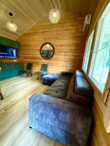 a living room with a couch in a cabin at Cottage scandinave 89 in Bourbourg