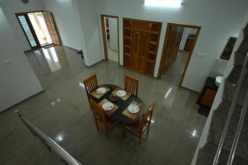 an overhead view of a table and chairs in a room at Prashanthi Home Stay Nature View in Bārkūr