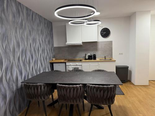 a kitchen with a table and chairs in a room at Stylish Stadlau Apartment - Free Parking in Vienna