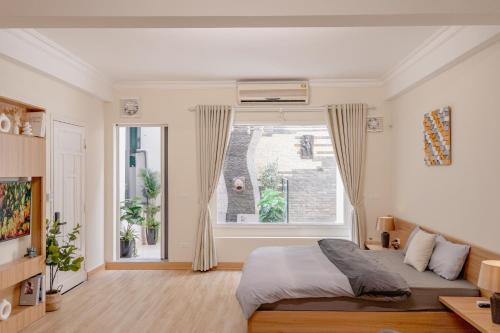 ハノイにあるModern Hotel 4- Old Quarter- AC-Netflix- Elevatorのベッドと大きな窓のある寝室