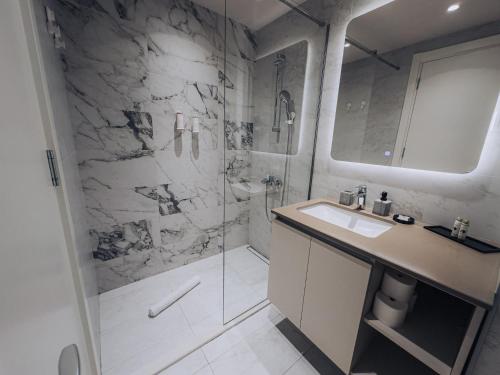 a bathroom with a shower and a sink and a toilet at Beograd na vodi - BW AURORA LUXURY in Belgrade