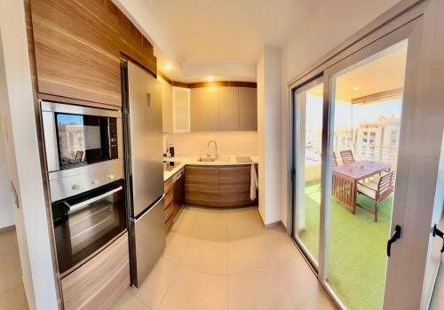 a small kitchen with a sink and a counter at Residencial La Loma in Águilas