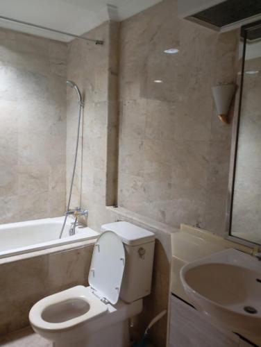 a bathroom with a toilet and a sink at Resa Living in Mantaak