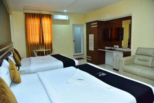Postel nebo postele na pokoji v ubytování hotel fortune suites