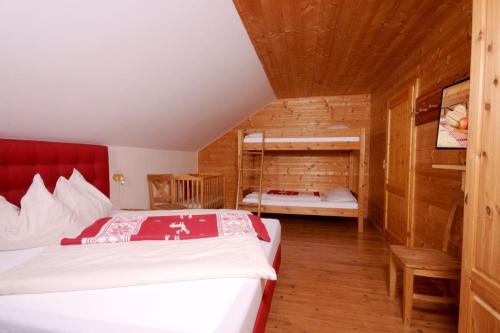 a bedroom with a bed in a wooden room at Skiurlaub und Wanderurlaub am Katschberg Almchalet am Katschberg by FeWo-Planlan in Katschberghöhe