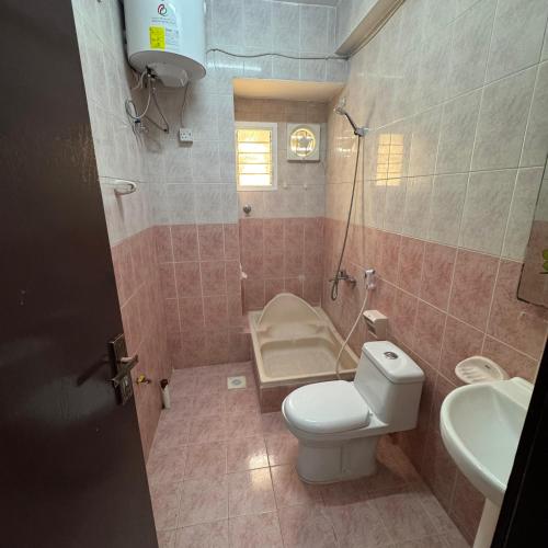a bathroom with a toilet and a sink at Ruslan in Muscat