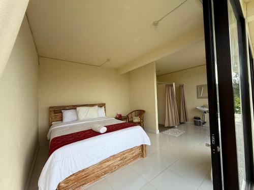 a bedroom with a bed in a room at Pondok Kenali Glamping in Kubupenlokan