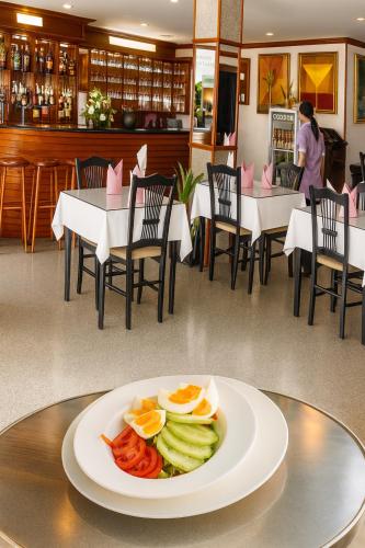a plate of food on a table in a restaurant at Orchid Hotel and Spa Kalim Bay in Patong Beach