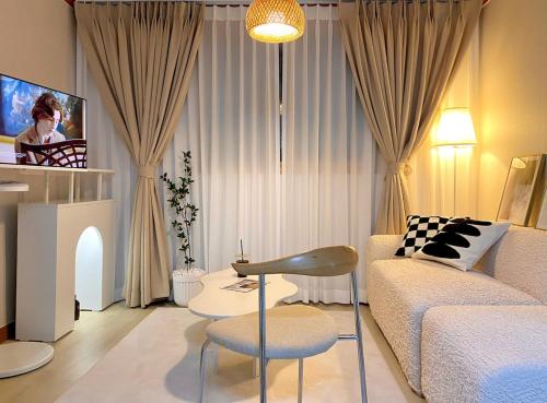 a living room with a couch and a tv at COZY BUTTERHOUSE, Near Metro, Close to Airport, Hongdae, WIFI, Long Biz Trip, Local Vibe in Seoul