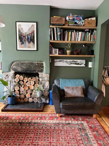 a living room with a couch and a fireplace at Bryn Y Gwynt, Betws y Coed in Betws-y-coed