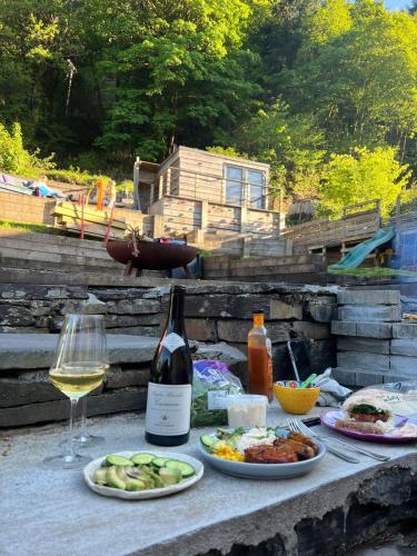 a table with plates of food and a glass of wine at Bryn Y Gwynt, Betws y Coed in Betws-y-coed